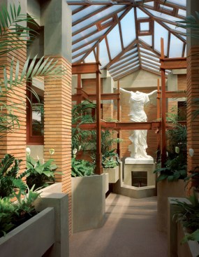 Wright designed the conservatory--much to Mrs. Darwin's chagrin--not as a place to sit and spend a quiet afternoon, but as the terminus of a visual axis from the main house, along the pergola, and to the stature of Nike (now a replacement from the original manufacturer). A window crank system was salvaged from a period greenhouse slated for demolition and installed to manage opening several windows at once for cross ventilation.