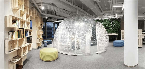 Custom-made+crates+affixed+to+the+wall+are+used+as+shelves+in+the+office+library.