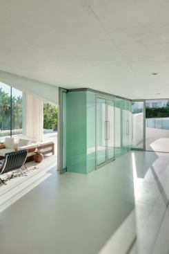 A curved ramp leads to the front entrance (at right), which opens onto the living room.