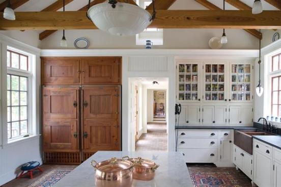 The new kitchen, with its brick floor, recalls the forms and materials of the existing house.