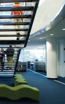 The bulk of the newspaper's employees work in the second and third floor newsrooms, connected by a large open stairwell to promote ready circulation between departments. The third floor ceiling is shaped by the folds of the roof, lending a sense of sculpture to the sea of cubicles. Fineline ceiling suspension system - USG - www.usg.com Narrow slotted profile - 1/4-inch reveal - Mitered intersections - Hotdipped galvanized steel construction - Optional air diffuser Millenia ceiling tiles - USG - www.usg.com Fine-textured acoustical panels - Inhibition of mold/mildew - High noise-reduction coefficients - Alternative to face-laminated panels
