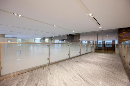 Railing infill in ViviGraphix Gradiance glass with Dot Mini Fade interlayer and Standard finish at HSBC Bank, New York, New York