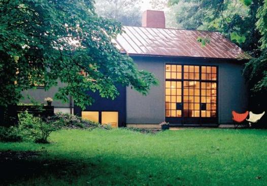 Before the renovation (far left), the house had little connection to the wooded yard and protected parkland beyond. The updated version (above), with its 10-foot-by-10-foot steel grid of windows and doors, offers direct connections to the outdoors. The master suites windows are elevated for privacy because they face the street (left). To increase the flow of natural light, polycarbonate panels substitute for walls and roofing.