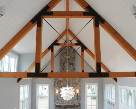 The douglas fir trusses function structurally and help define the different spaces below.