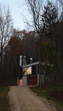 A winding dirt road leads up to the home.