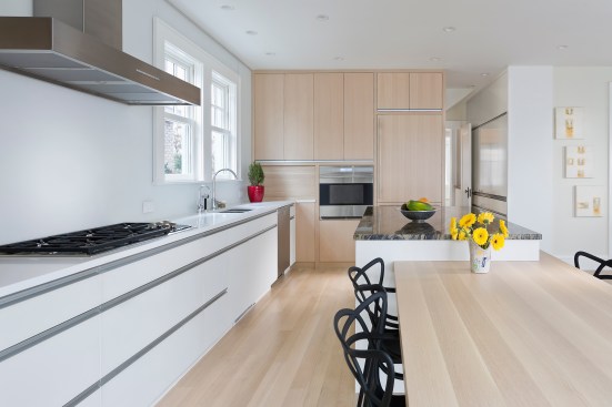 Modern upscale kitchen with combination of light wood and white cabinets