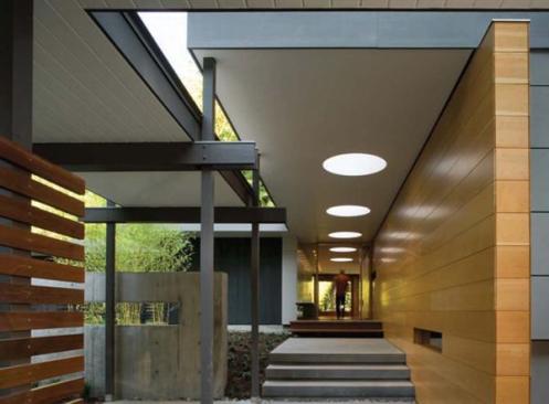 The living areas level change and concrete floor reinforce the sense of a pavilion in the woods.