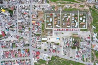 Aerial view of the Apan Housing Laboratory, which was master planned by MOS. The welcome and education center designed by MOS is at the base of the site, adjacent to 32 affordable house prototypes, each designed by a different firm.