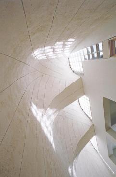 On the opposite end of the house from the saw-tooth configuration, three half-domed, asphalt-clad towers bring light into the space.