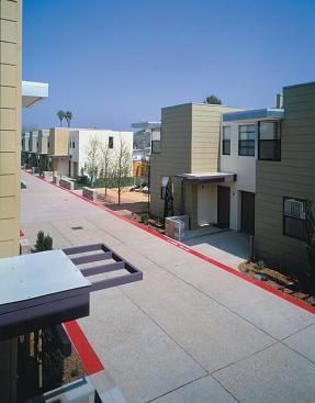 A community center, covered front stoops, and a common area with a playground provide residents of the Eleventh Avenue Townhomes with places to socialize. Studio E assembled the traditional elements of developer housing stucco, cement-board siding, alumin