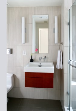 The renovated bathroom's utilities had to be reoriented to follow the new direction of space within the basement.