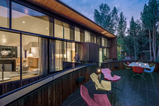 A deck on top of the guest suite is accessible from the second-floor kitchen in the main house, and provides outdoor dining.