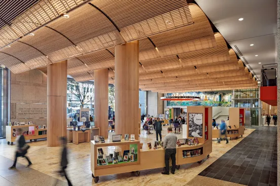Boylston Hall, the library’s new two-story multifunctional space, opens the building to the street and features a wooden vaulted ceiling, mobile carts, and welcoming general light.