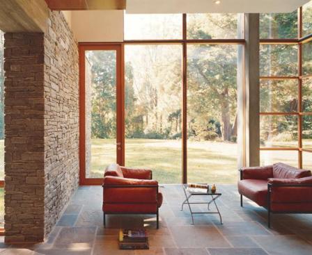 Pinpoint siting, earthy materials, and walls that seem to disappear fully engage this suburban home in the outdoors.