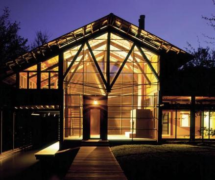 The transparent "boathouse" supplies the homes primary entry point.