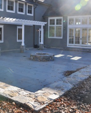 Rear terrace with fire pit and pergola.