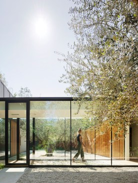 Glass hallway connecting living and guest pavilions 