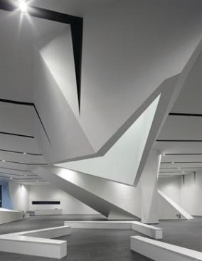 A+skylit+atrium+extends+through+the+building%2c+terminating+in+an+articulated+aperture+over+a+seating+area+in+the+ground-floor+gallery.