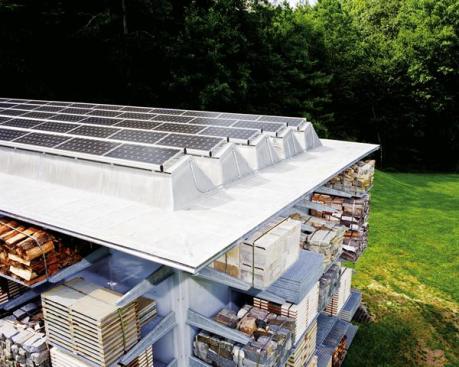 Translucent photovoltaic panels are integrated into skylights on the building's roof. The system produces more than enough energy to power the building, allowing the client to recoup principal costs for the system more quickly by selling the excess electricity back to the local utility company.