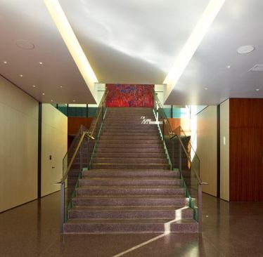 A back area of the old post office is now a walkway leading to a staircase that ducks below grade into the lobby of the newly added theater building. 