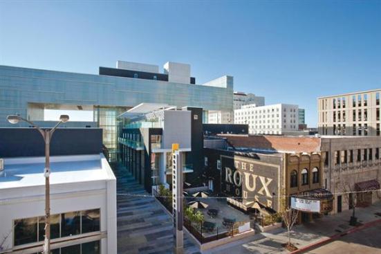 The OneEleven building marries the ambiguously scaled Shaw Center behind it to the streetscape in front.