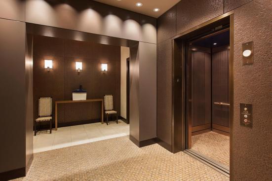 Wall and elevator surrounds shown in Bonded Bronze with Dark Patina and custom pattern; also shown, LEVELe-105 Elevator Interior with main panels in Bonded Bronze with Dark Patina and Mazatl?n pattern; accent panels in Bonded Bronze with Dark Patina and custom pattern at Residences at the InterContinental, Boston, Massachusetts