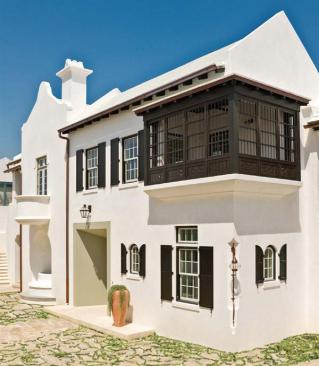 The architects conceived the house as a solid white block with carved-out exterior spaces.