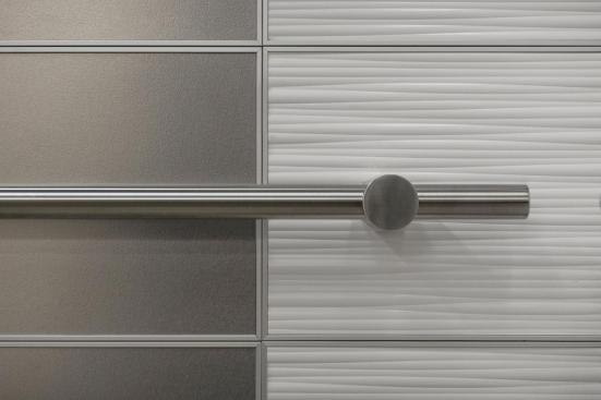 LEVELe-103 Elevator Interior with main panels in Stainless Steel with Sandstone finish; accent panels in Bonded Quartz, White with Kalahari pattern; Compass handrails in Satin Stainless Steel with Cylinder standoff at Florida Hospital Celebration Health, Celebration, Florida