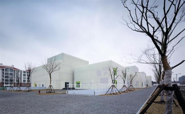 Many+of+the+building+volumes+are+clad+in+perforated+metal+screens+attached+to+brightly+colored+concrete+walls.+Cutouts+in+the+screens+reveal+insulating+low-E+glazing+from+Zhuogao+Glass.