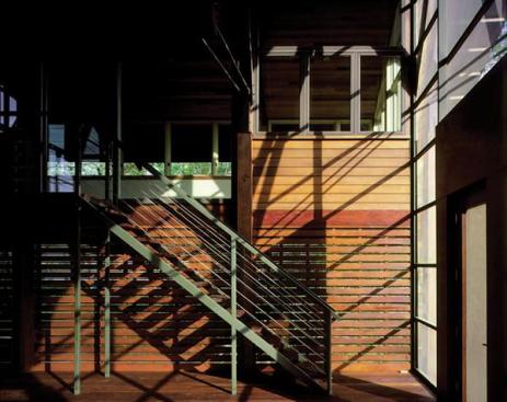 The transparent "boathouse" supplies the homes primary entry point.