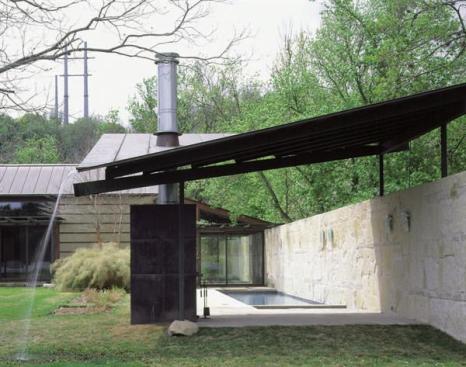 Though the house is just across Lake Austin from the citys downtown, the architects managed to preserve its rural feel. Another stone wall at the rear of the site makes a private outdoor room of the pool area and shields a neighboring property from view