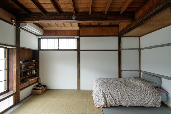Renovated bedroom feels wider with the exposed ceiling structure