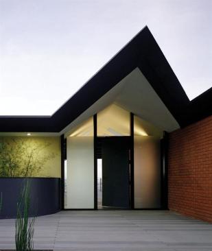 The street-level entry was pared down and simplified, both inside and out, in order to emphasize its angular architecture.