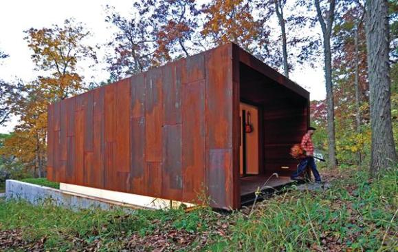 This buildings rusty metal shell was inspired by picturesque abandoned farm implements in the surrounding forest.