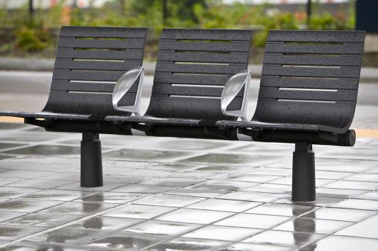 Tecno RS Seating System shown in three-seat, backed configuration with Black Texture powdercoated frame and seats, Silver Texture powdercoated angled armrests, and cylindrical mounting posts at Sound Transit, Seattle, Washington