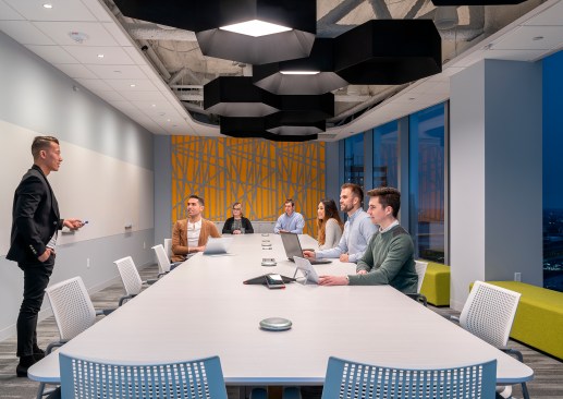Conference rooms feature hexagon-shaped luminaries, designed to emulate the company’s logo. 