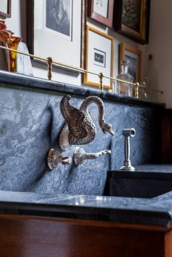 Cabinets crafted to match the old boast an integrated soapstone sink and vintage faucet.