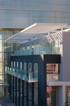 Glass balconies animate the alley below.