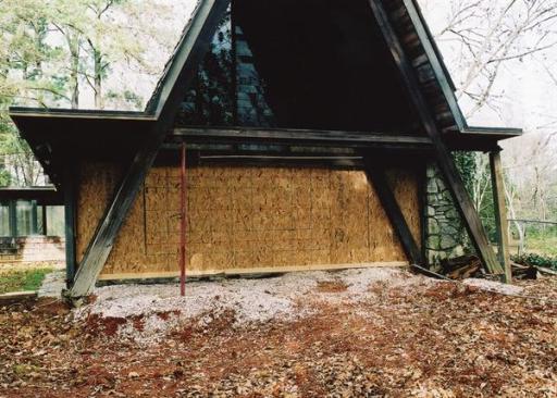 Designer Brian Pittman ushered this home into the 21st century with a sure and gentle hand. The original A-frame house (shown after preparation for renovation) was designed by Felder Weeks and much loved by its owners.