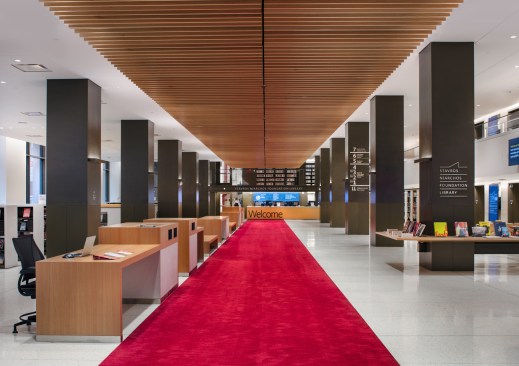 SNFL’s ground floor is arranged around an internal street that runs beneath a floating linear canopy of wood beams, from the Fifth Avenue entrance to the welcome desks.
