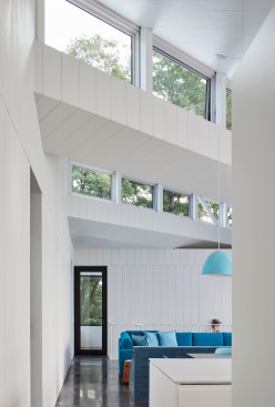 View from the main entrance looking toward the livingroom with screenporch beyond