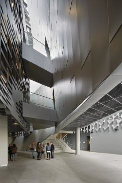 The organically shaped form between the two dorm towers contains performance spaces, administrative offices, and classrooms, including a distance learning room facing onto Sunset Boulevard. For Mayne, the play between indoor and outdoor areas is more analogous to the older urban fabrics in Europe and Asia, not Los Angeles. “We built a little town. I am fascinated by the accidental feel of cities more than the formal,” he says. “The building is filled with interstitial spaces.”

