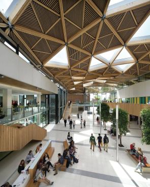 Natural light pours in through triangular
bays filled with EFTE rooflights by London-based Vector Foiltec, chosen
because they are lighter than conventional double glazing. Each 48
square feet EFTE light consists of a three-layer cushion with a random
printed frit pattern. Double-glazed windows cover the triangular
openings in teaching and study areas to reduce rain noise.
“We originally envisioned more glass, but we ended up with half the
number of light bays based on daylight modeling,” Critchlow says. “You
can have too much light, especially when students are working on
computers.”