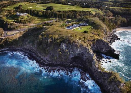 The beach house sits atop a rocky point of land where two bays meet in dramatic fashion.