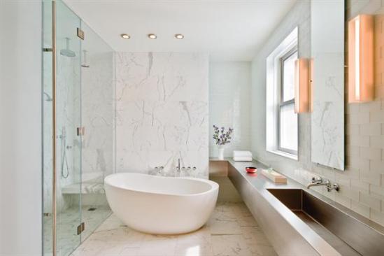 A modern, marble and steel master bath. 