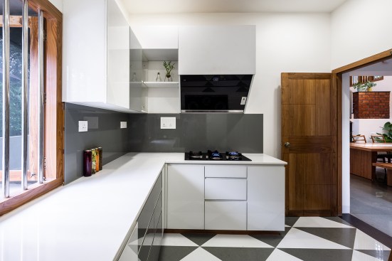 Kitchen holds a grey and white blend in its flooring,counter and Dado