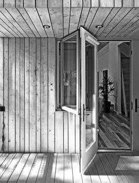 The casement window and terrace doors on the rear deck provide views to the forest.