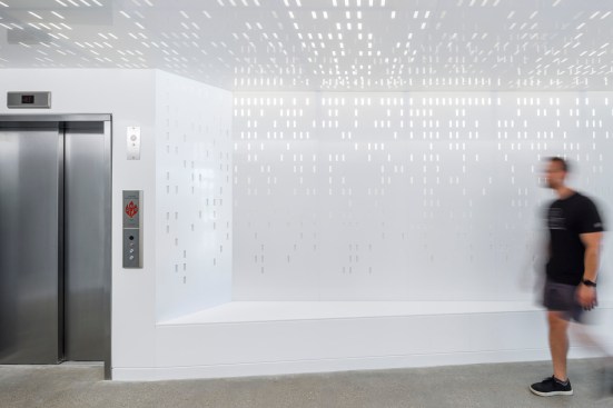 Backlit, punctuated panels express the technological orientation of the building's inhabitants.