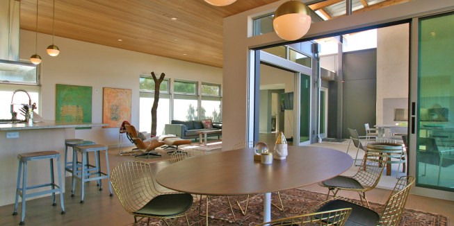 The exterior says “contemporary” but the interior basks in splashes of Mid-Century Modern glory.  

The exterior says “contemporary” but the interior basks in splashes of Mid-Century Modern glory.  
