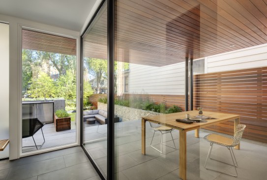 Large glass doors and windows make this space feel as though these two spaces are connected